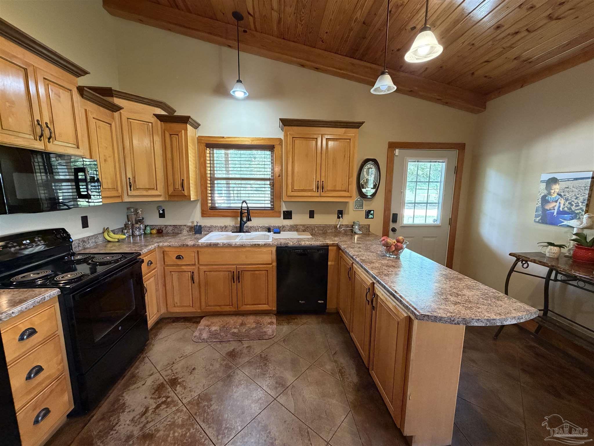 145 Tower Road Uriah, AL 36480 - Photo 4 of 72 a kitchen with a sink stove and wooden cabinets