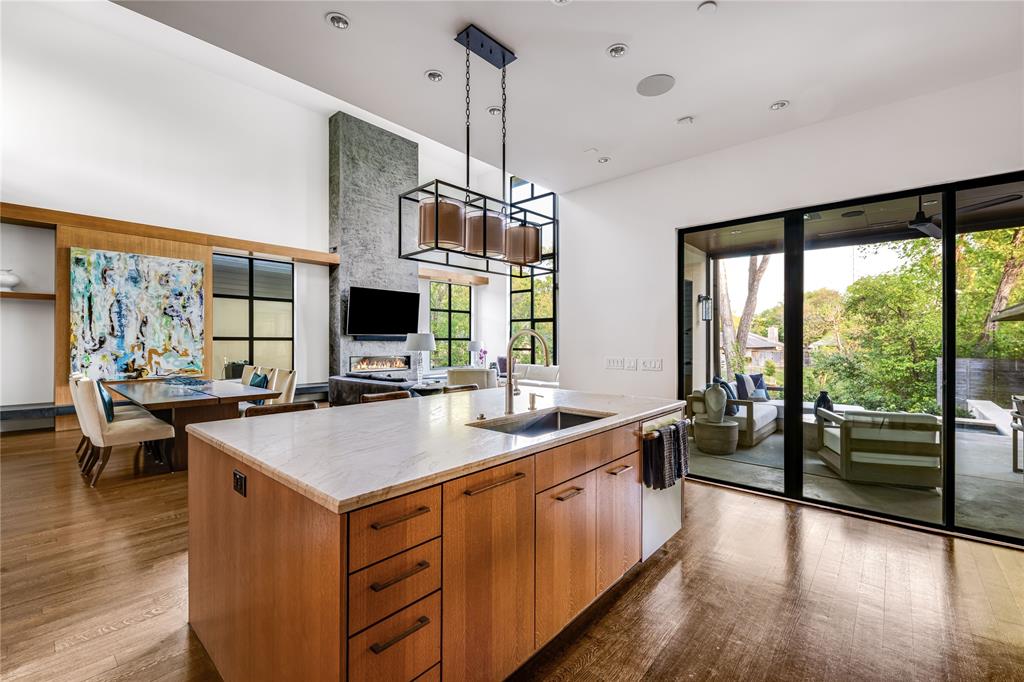 11460 Strait Lane Dallas, TX 75229 - Photo 14 of 39 a large kitchen with kitchen island a large island in it