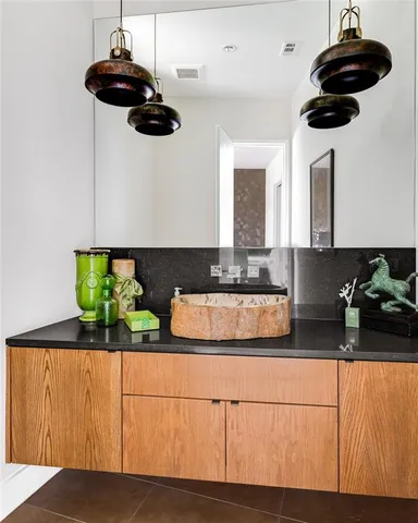 a kitchen with stainless steel appliances granite countertop a sink a stove and cabinets