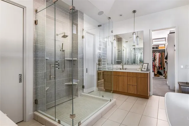 a bathroom with a shower a sink and mirror