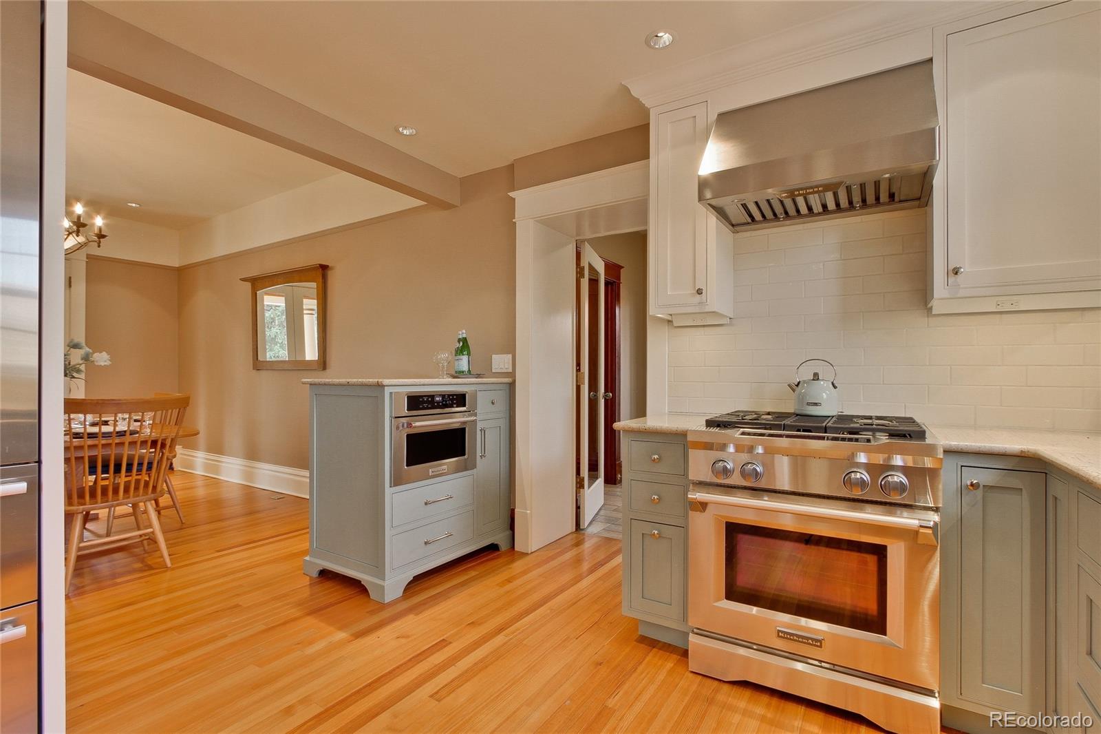 935 10th Street Boulder, CO 80302 - Photo 13 of 40 a kitchen with granite countertop a stove and a wooden floors