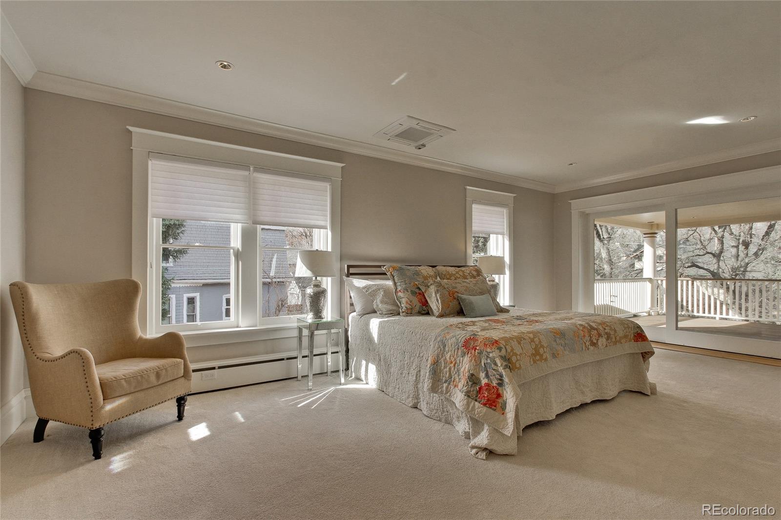 935 10th Street Boulder, CO 80302 - Photo 17 of 40 a spacious bedroom with a bed and a couch next to a window