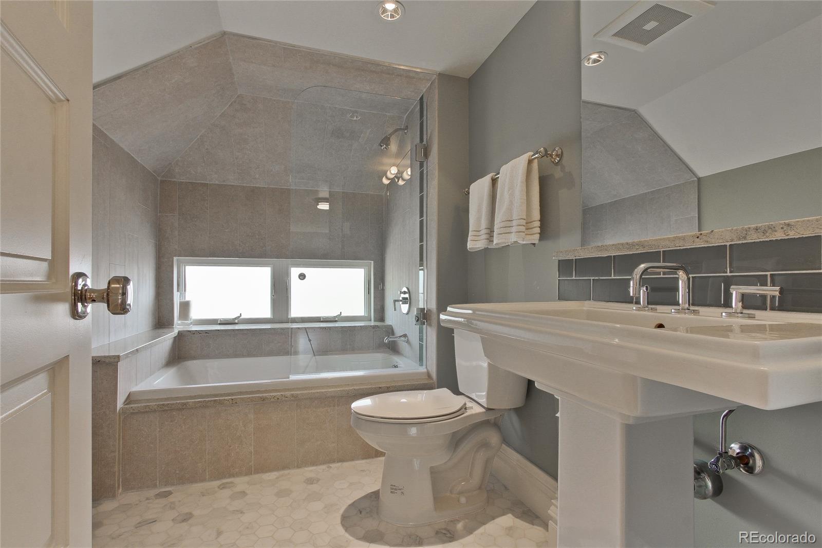 935 10th Street Boulder, CO 80302 - Photo 28 of 40 a bathroom with a bathtub shower sink and toilet