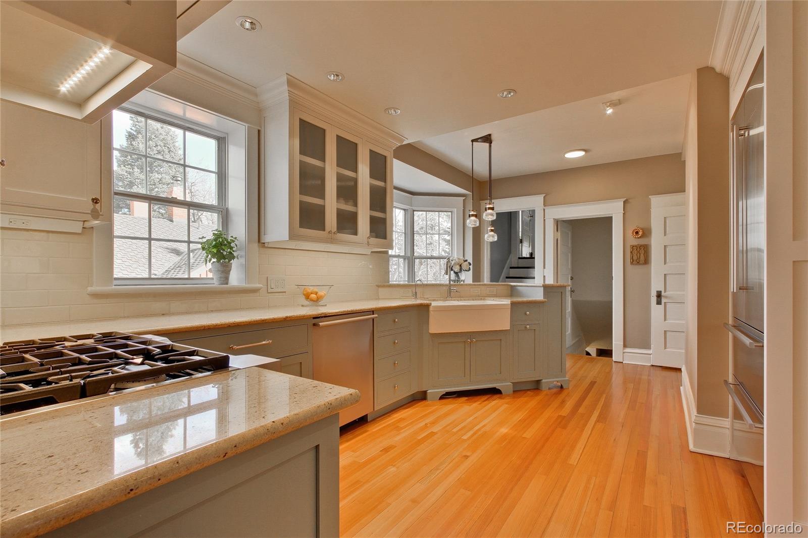 935 10th Street Boulder, CO 80302 - Photo 10 of 40 a kitchen with stainless steel appliances granite countertop a sink stove and refrigerator