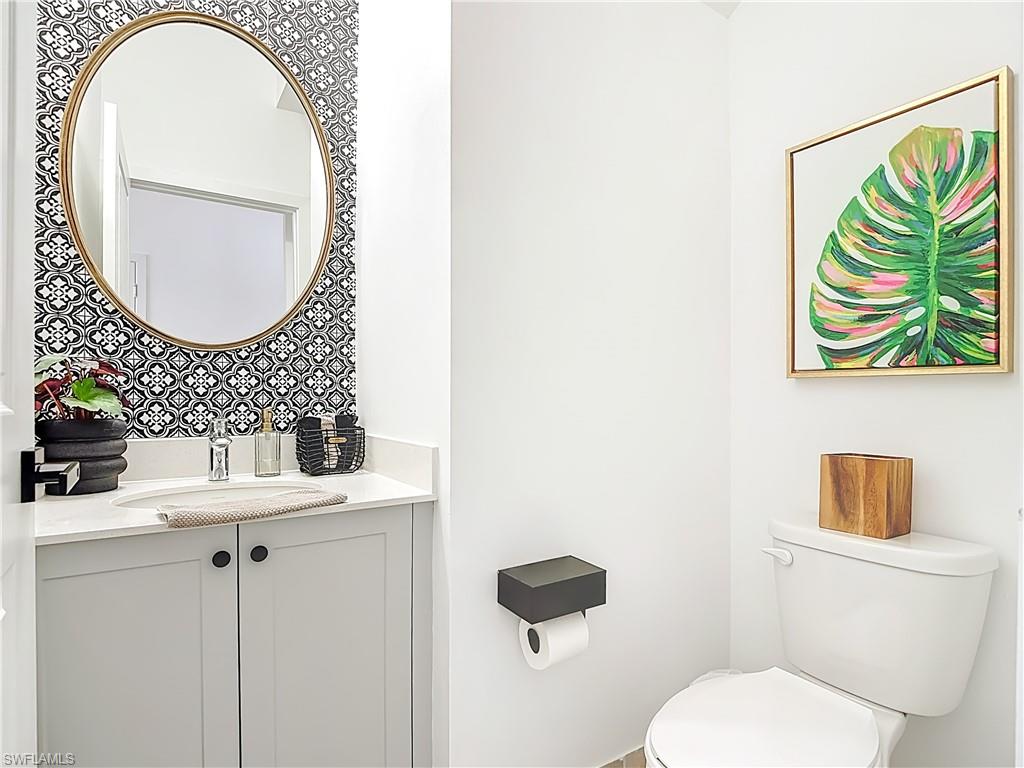 5502 Cassidy Lane Immokalee, FL 34142 - Photo 11 of 20 a bathroom with a sink a mirror a toilet and a mirror