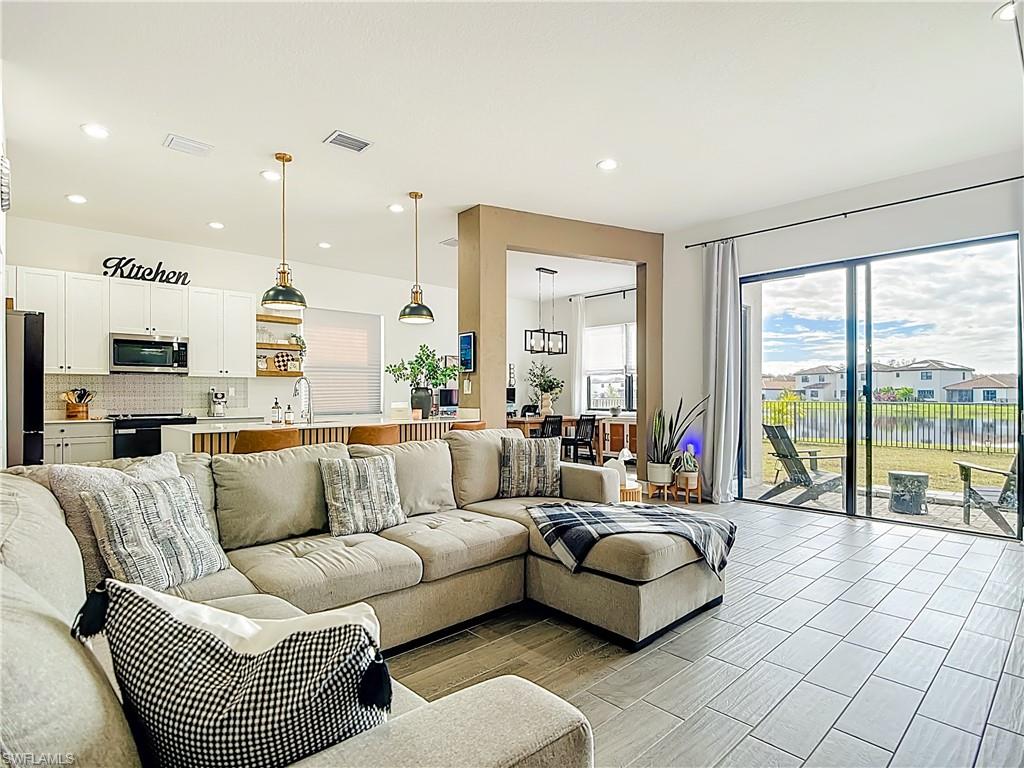 5502 Cassidy Lane Immokalee, FL 34142 - Photo 4 of 20 a living room with furniture and a large window