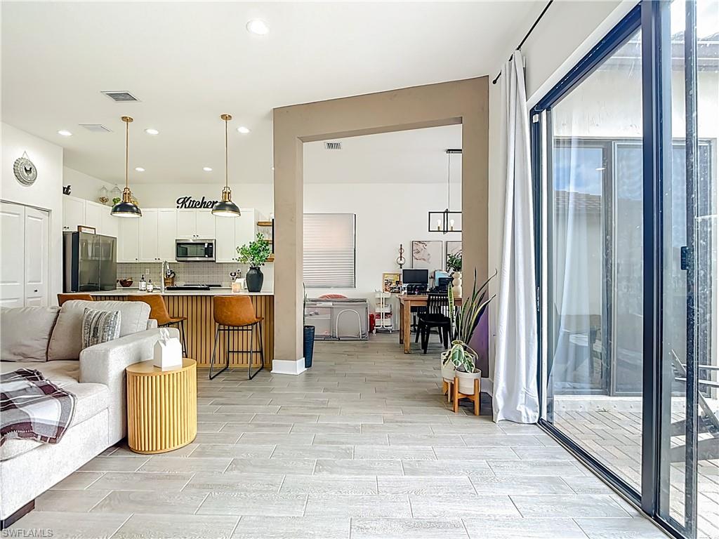 5502 Cassidy Lane Immokalee, FL 34142 - Photo 5 of 20 a view of a living room and kitchen view