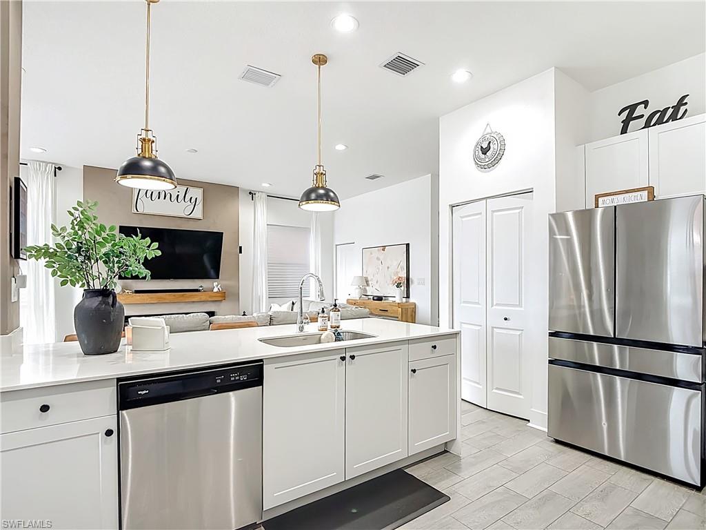 5502 Cassidy Lane Immokalee, FL 34142 - Photo 8 of 20 a kitchen with a sink and refrigerator