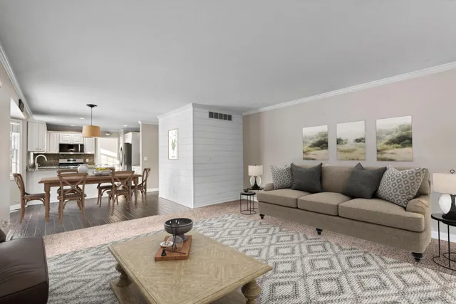 a bathroom with a granite countertop toilet a sink a mirror a shower and a window