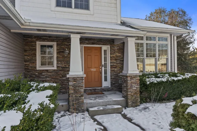 a view of a white house with a yard covered with snow in front of house