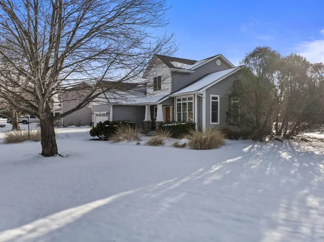 a view of a livingroom with wooden floor and electronic appliances