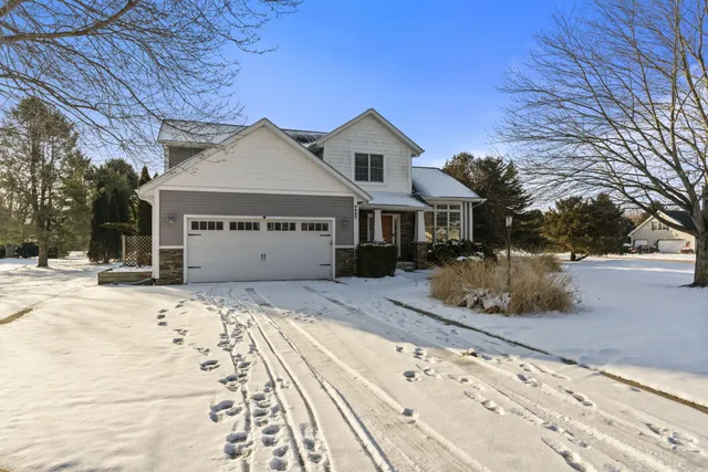 a view of staircase with wooden floor and front door