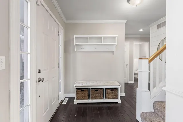 a kitchen with stainless steel appliances granite countertop a refrigerator a stove top oven a sink and dishwasher with wooden floor