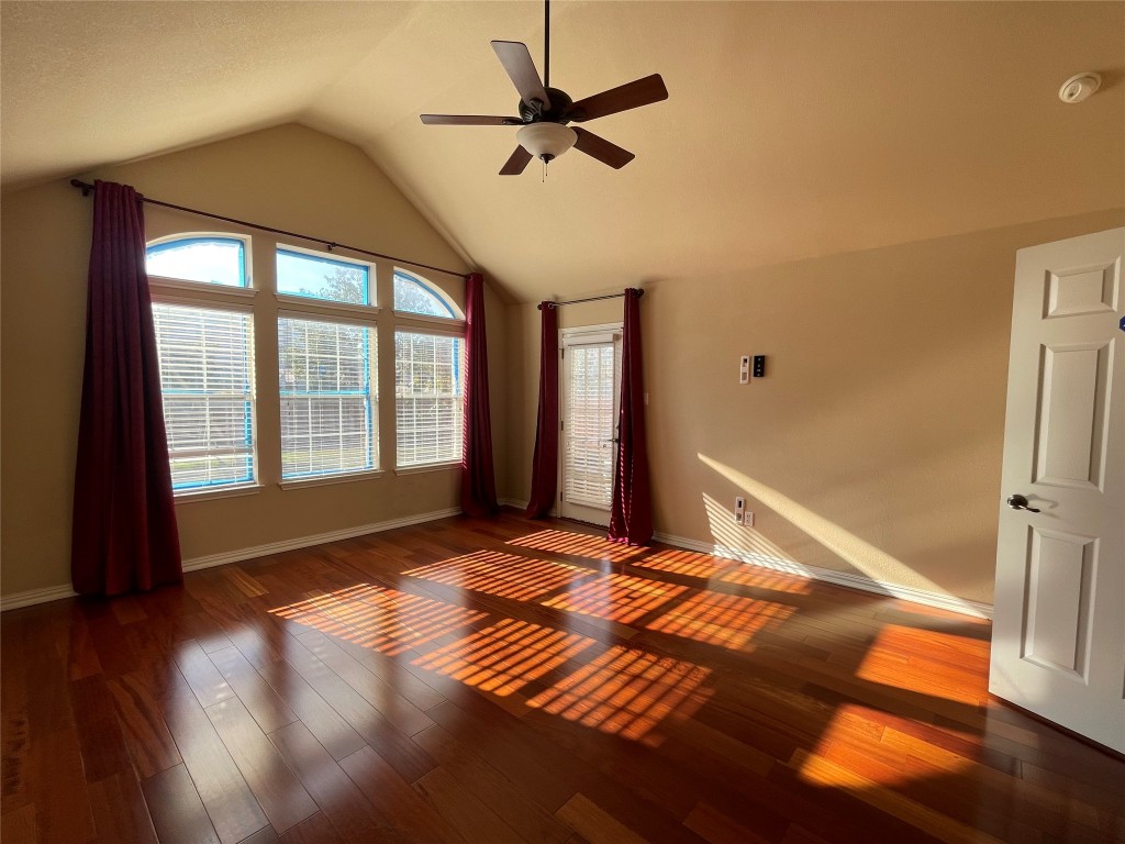 15529 Staked Plains Loop Austin, TX 78717 - Photo 11 of 32 Spare room with wood finished floors, a ceiling fan, and high vaulted ceiling