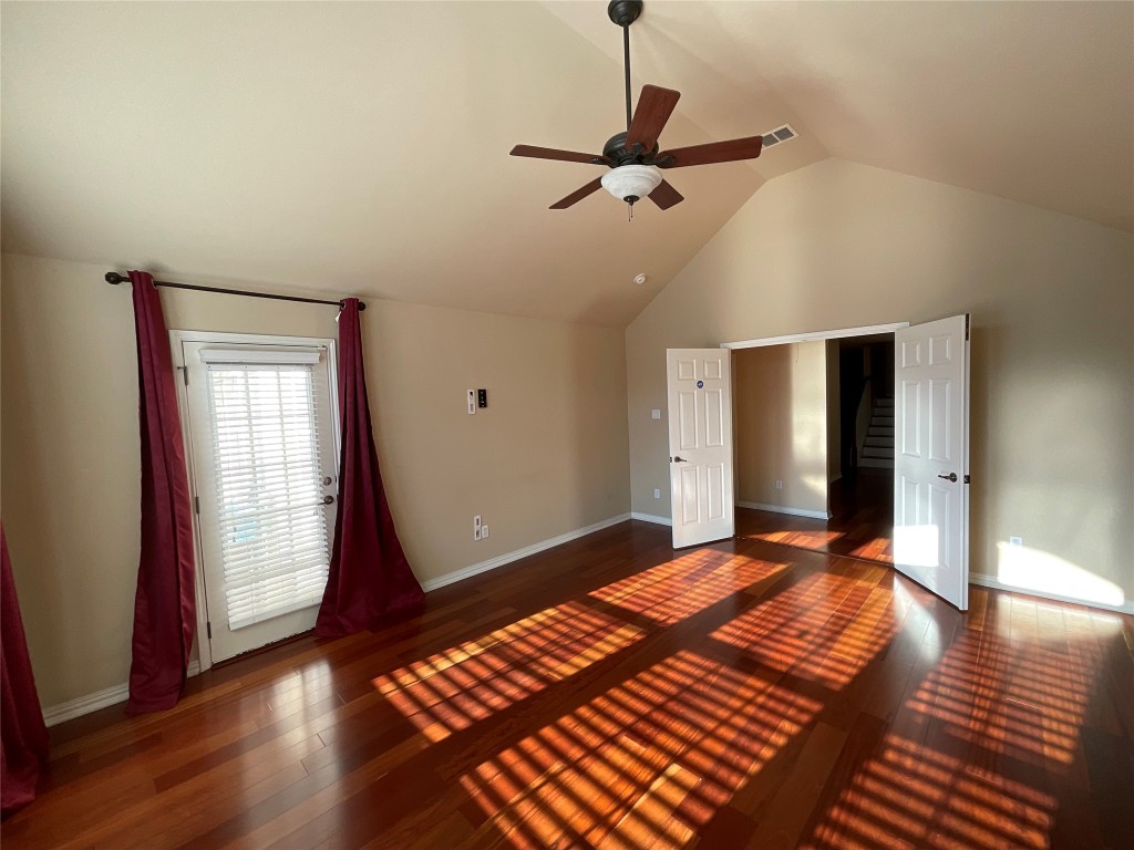 15529 Staked Plains Loop Austin, TX 78717 - Photo 13 of 32 Unfurnished bedroom with dark wood-style flooring, ceiling fan, and high vaulted ceiling