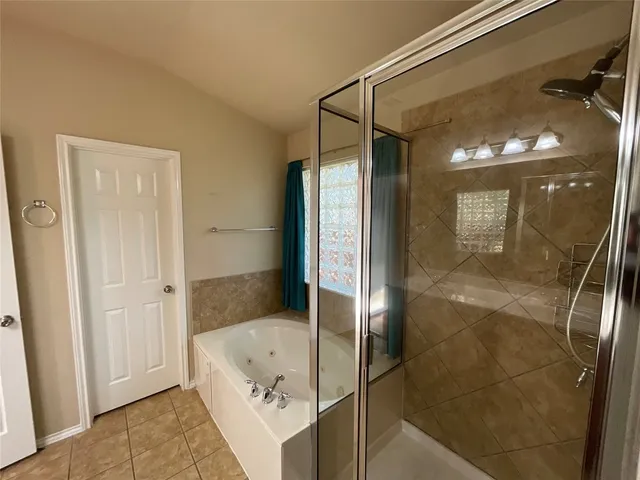 a bathroom with a tub and shower
