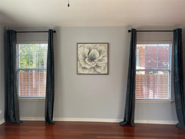 a view of room with window and wooden floor