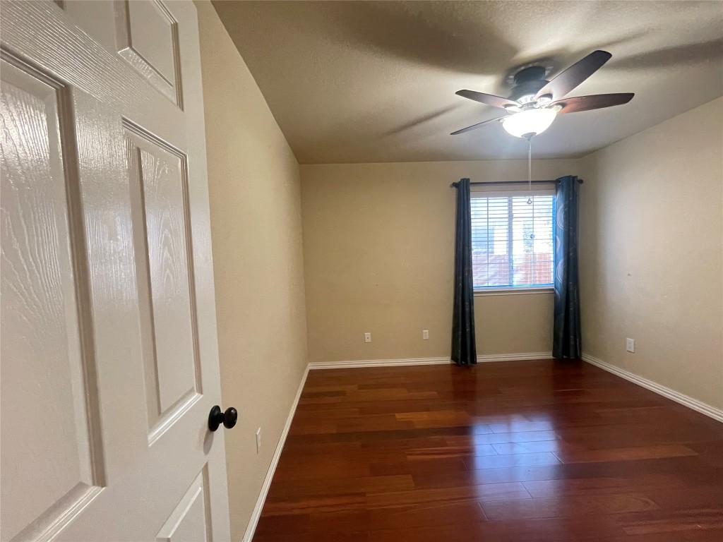 15529 Staked Plains Loop Austin, TX 78717 - Photo 24 of 32 Empty room with dark wood-style flooring, a ceiling fan, and a textured ceiling