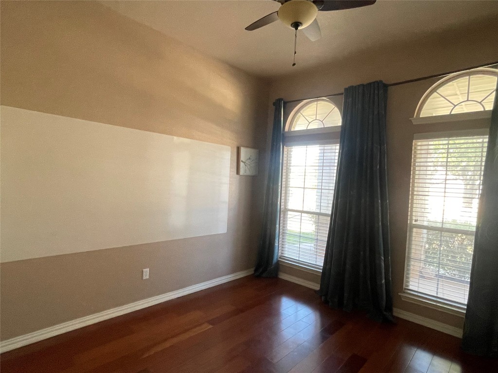 15529 Staked Plains Loop Austin, TX 78717 - Photo 26 of 32 Empty room featuring dark wood-style flooring and a ceiling fan