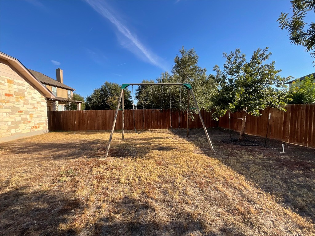 15529 Staked Plains Loop Austin, TX 78717 - Photo 29 of 32 Fenced backyard featuring a playground