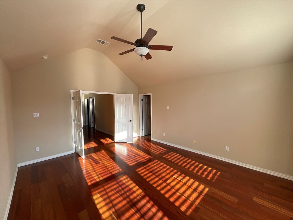 15529 Staked Plains Loop Austin, TX 78717 - Photo 10 of 32 Unfurnished bedroom featuring high vaulted ceiling, dark wood-type flooring, and a ceiling fan
