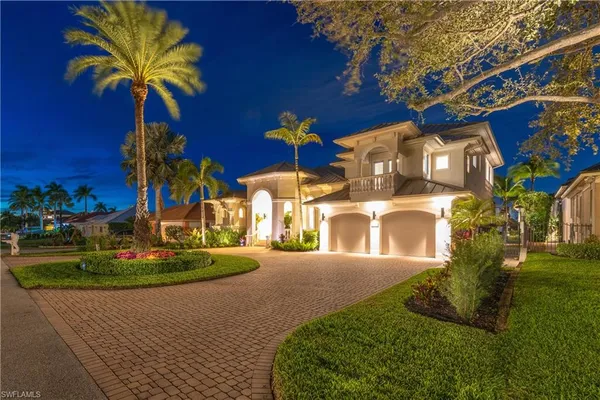 a front view of a house with a yard and a garage