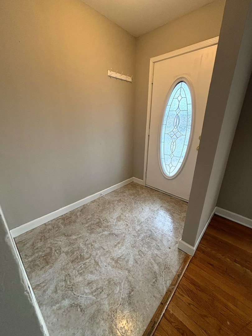 66 East Blecke Avenue, Unit 66 Addison, IL 60101 - Photo 2 of 14 a view of a hallway with wooden floor