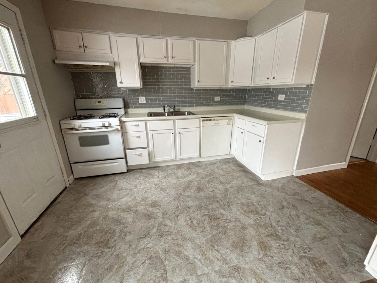 66 East Blecke Avenue, Unit 66 Addison, IL 60101 - Photo 4 of 14 a kitchen with white cabinets and white appliances