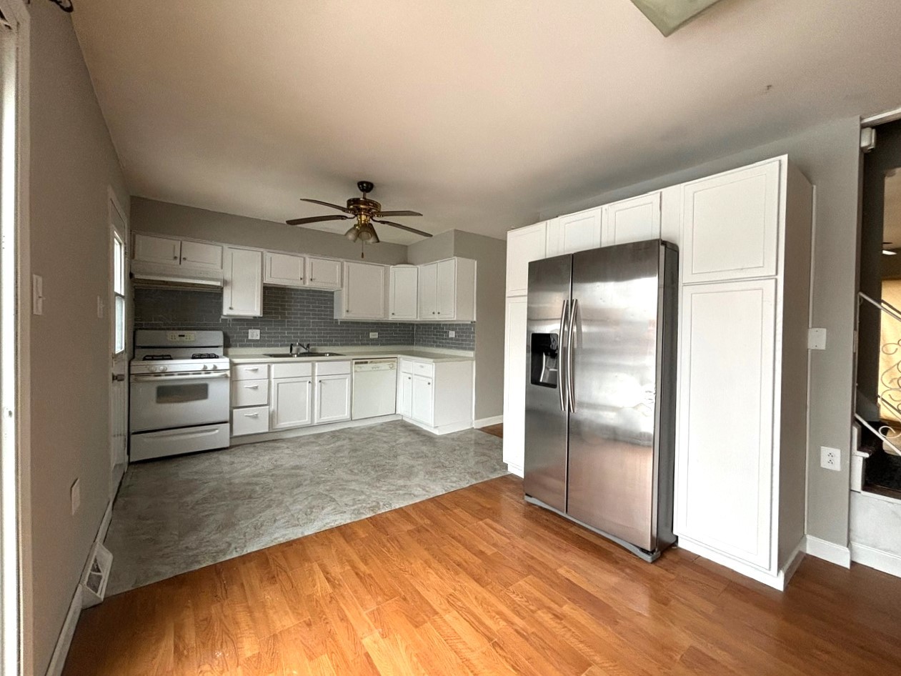 66 East Blecke Avenue, Unit 66 Addison, IL 60101 - Photo 5 of 14 a kitchen with granite countertop a refrigerator and a stove top oven