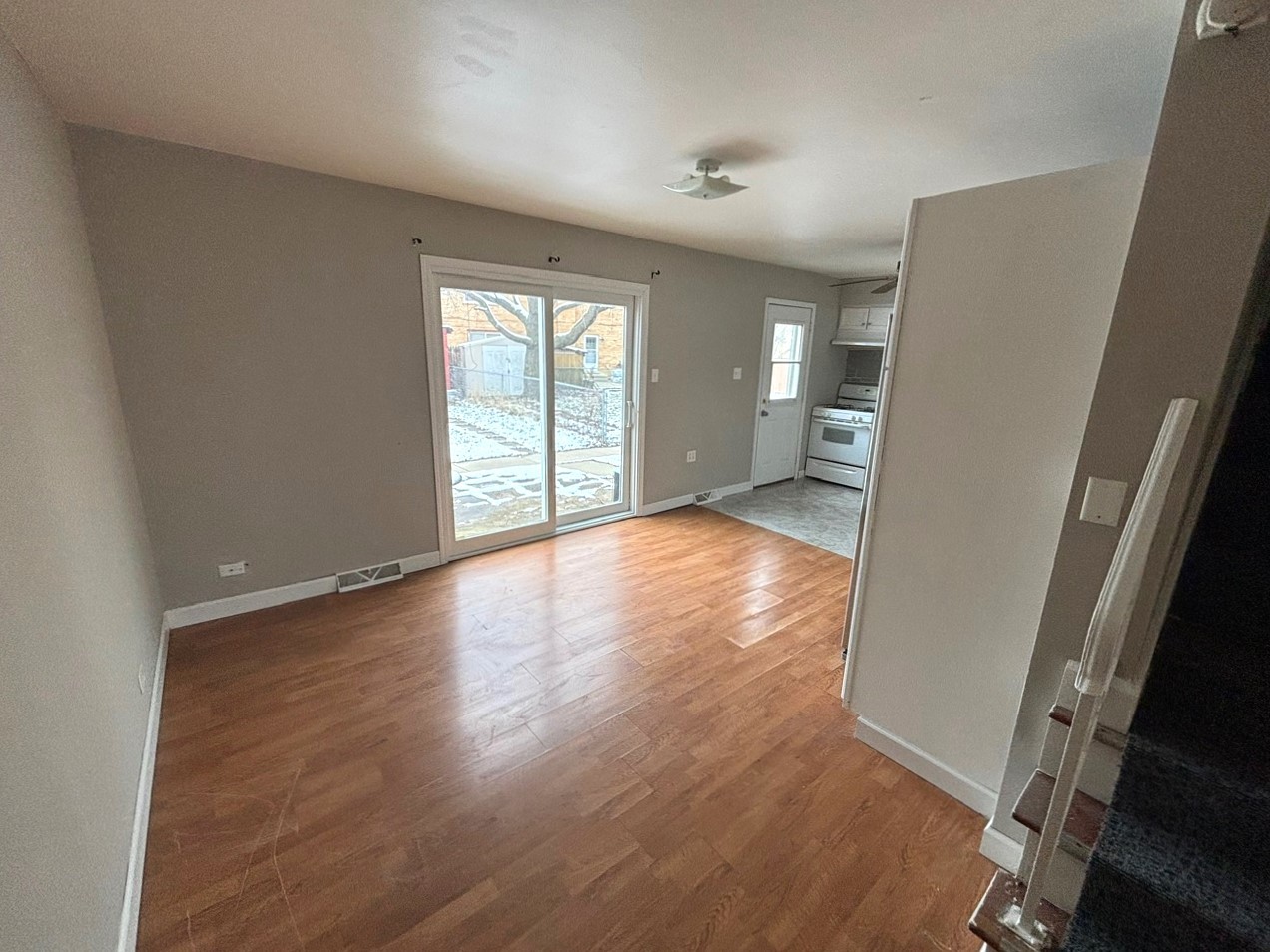 66 East Blecke Avenue, Unit 66 Addison, IL 60101 - Photo 6 of 14 wooden floor in an empty room with a window