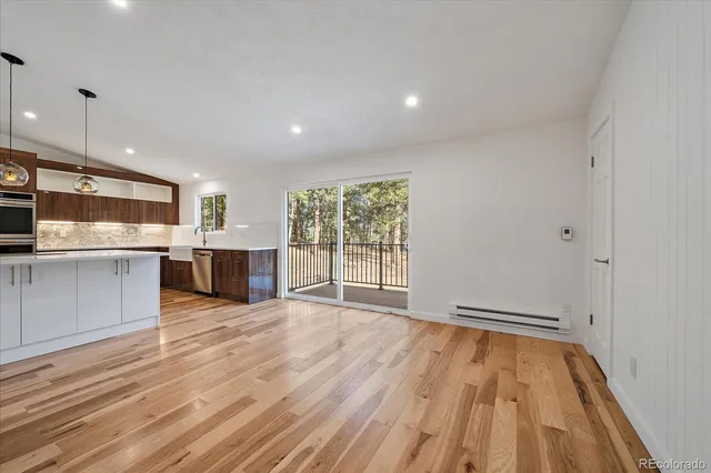 a view of kitchen with granite countertop cabinets and wooden floor