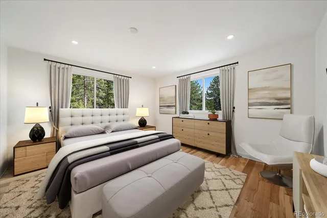 a bedroom with a bed and wooden floor