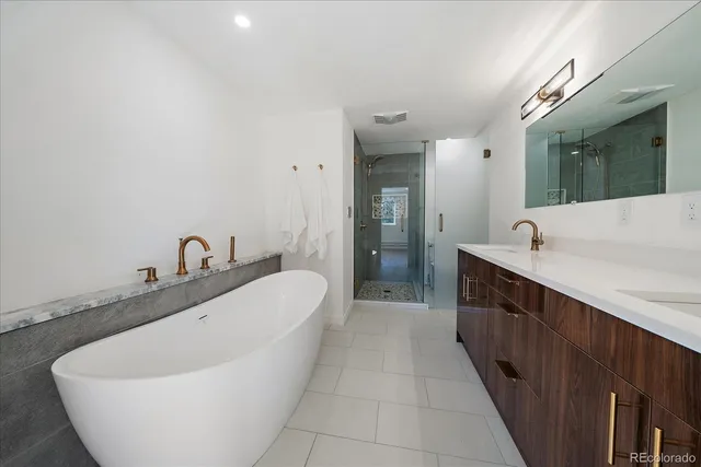 a spacious bathroom with a bathtub and sink