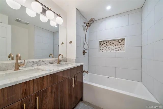 a bathroom with a tub sink and mirror