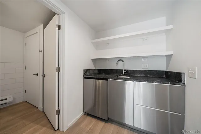 a close view of a kitchen counter space and stainless steel appliances