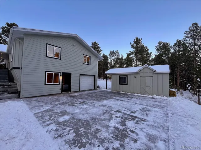a house that has a tree in front of it