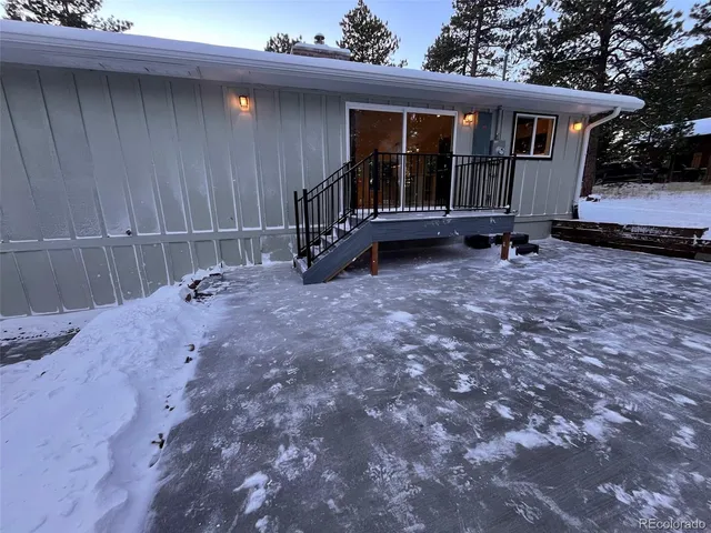 a view of house with backyard and deck