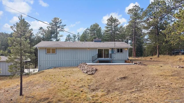 a front view of a house with a yard covered in snow