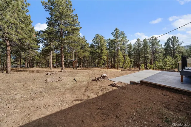 an aerial view of a house with a yard and trees