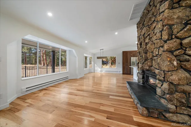 a big room with wooden floor and windows