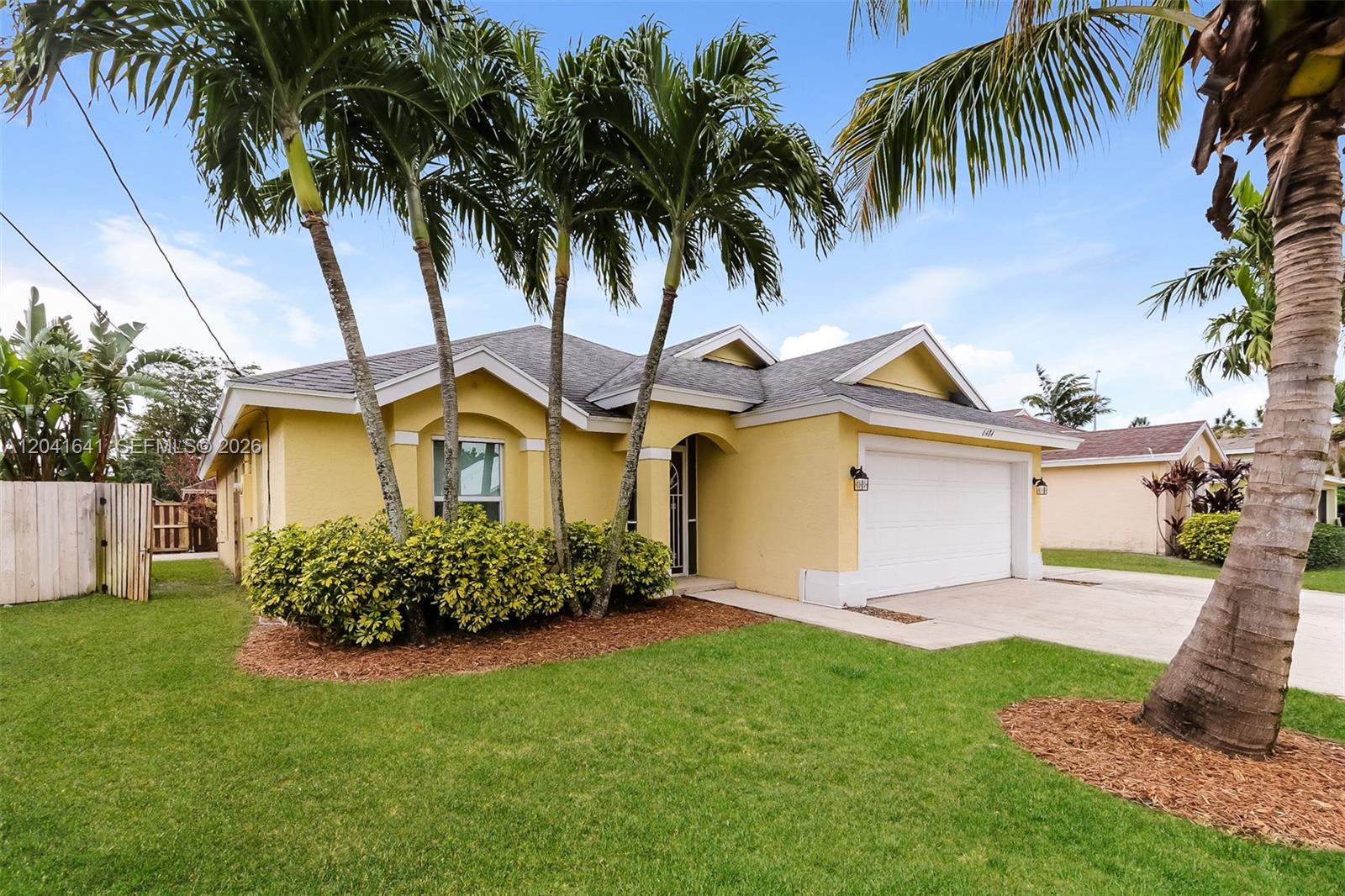 6484 Robinson Street Jupiter, FL 33458 - Photo 2 of 15 a front view of a house with garden