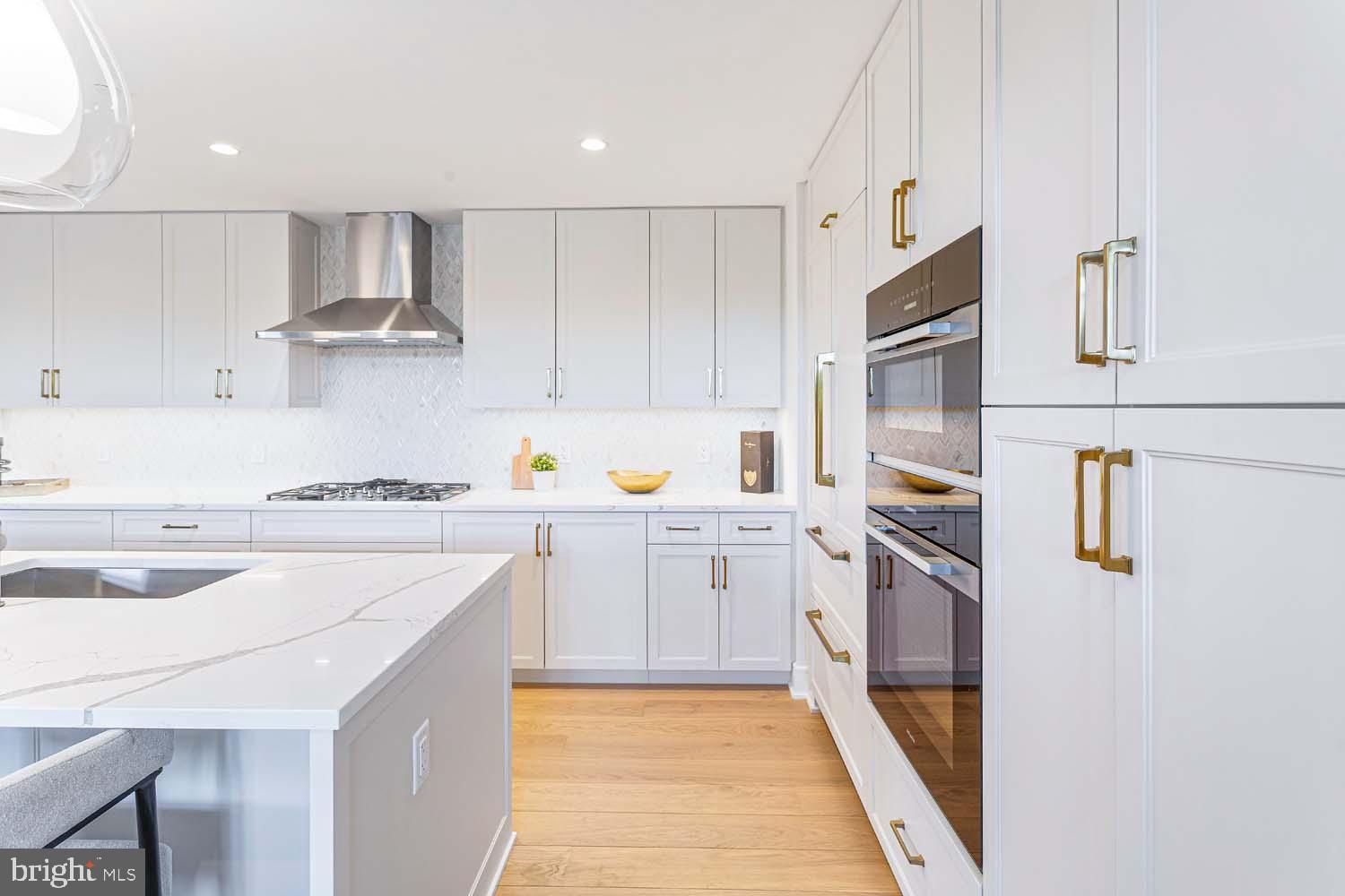 6718 Lowell Avenue, Unit 406 McLean, VA 22101 - Photo 10 of 86 a kitchen with a sink a stove top oven and white cabinets