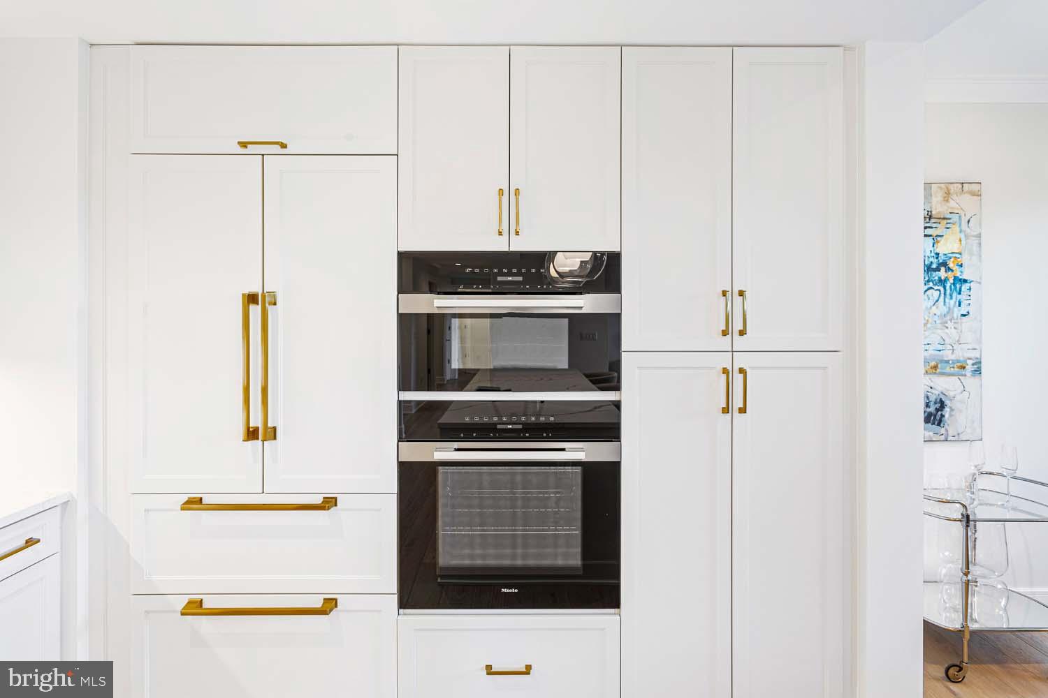 6718 Lowell Avenue, Unit 406 McLean, VA 22101 - Photo 12 of 86 a kitchen with a refrigerator and a stove