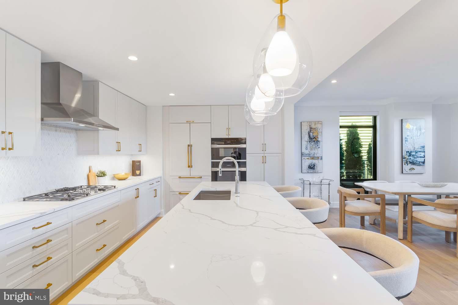 6718 Lowell Avenue, Unit 406 McLean, VA 22101 - Photo 14 of 86 a large white kitchen with stainless steel appliances