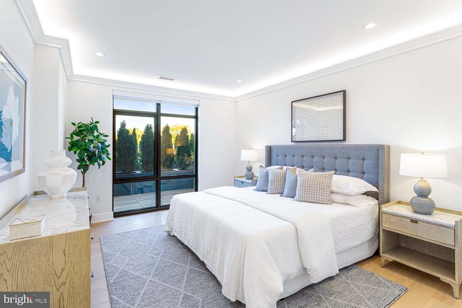 6718 Lowell Avenue, Unit 406 McLean, VA 22101 - Photo 19 of 86 a bedroom with a large bed and a large window