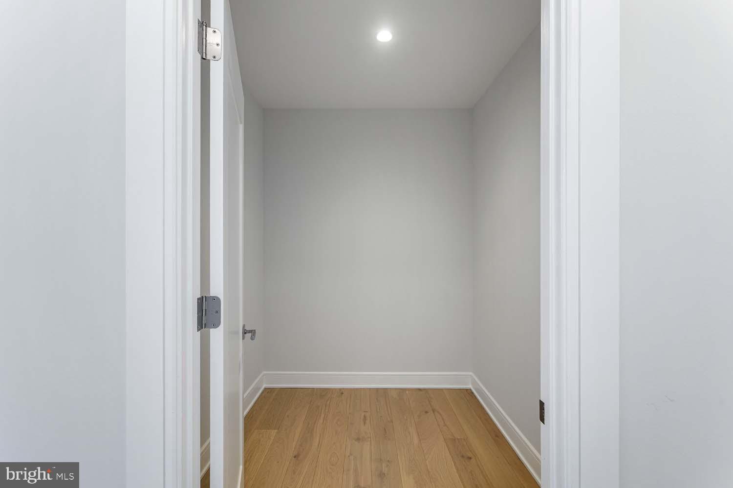 6718 Lowell Avenue, Unit 406 McLean, VA 22101 - Photo 22 of 86 a view of a hallway with wooden floor