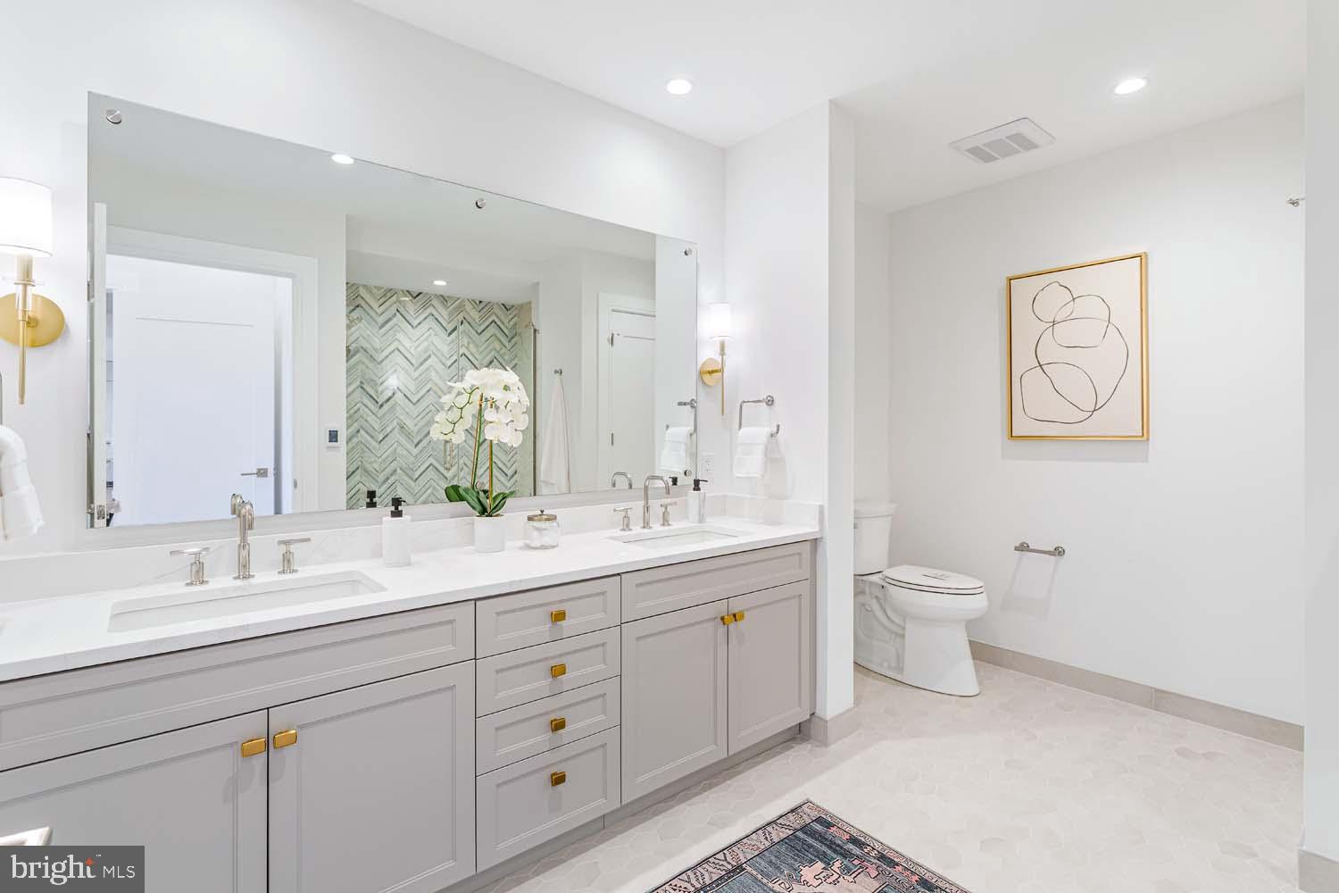 6718 Lowell Avenue, Unit 406 McLean, VA 22101 - Photo 24 of 86 a spacious bathroom with a double vanity sink toilet and a mirror