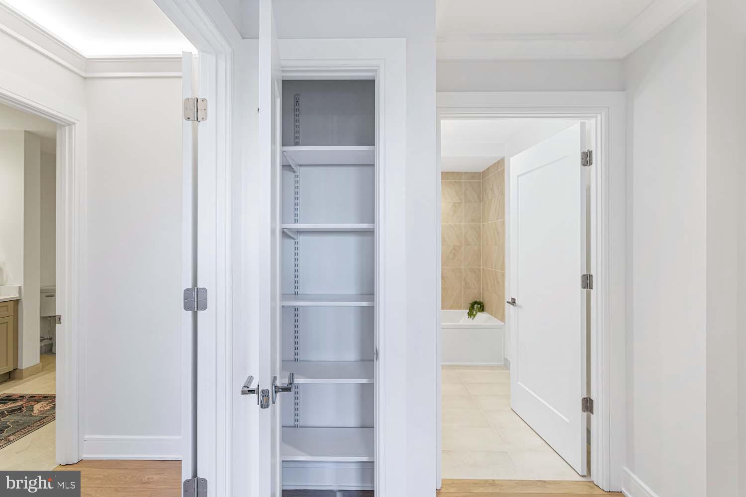 6718 Lowell Avenue, Unit 406 McLean, VA 22101 - Photo 34 of 86 a view of a hallway with wooden floor and closet