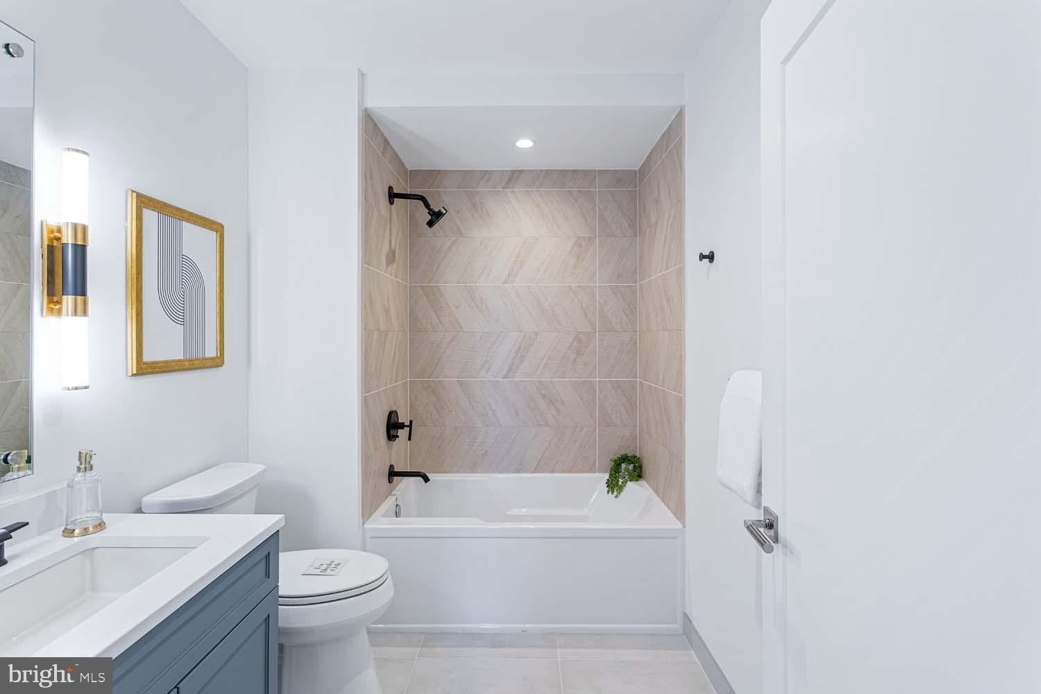 6718 Lowell Avenue, Unit 406 McLean, VA 22101 - Photo 35 of 86 a bathroom with a sink a toilet and bathtub