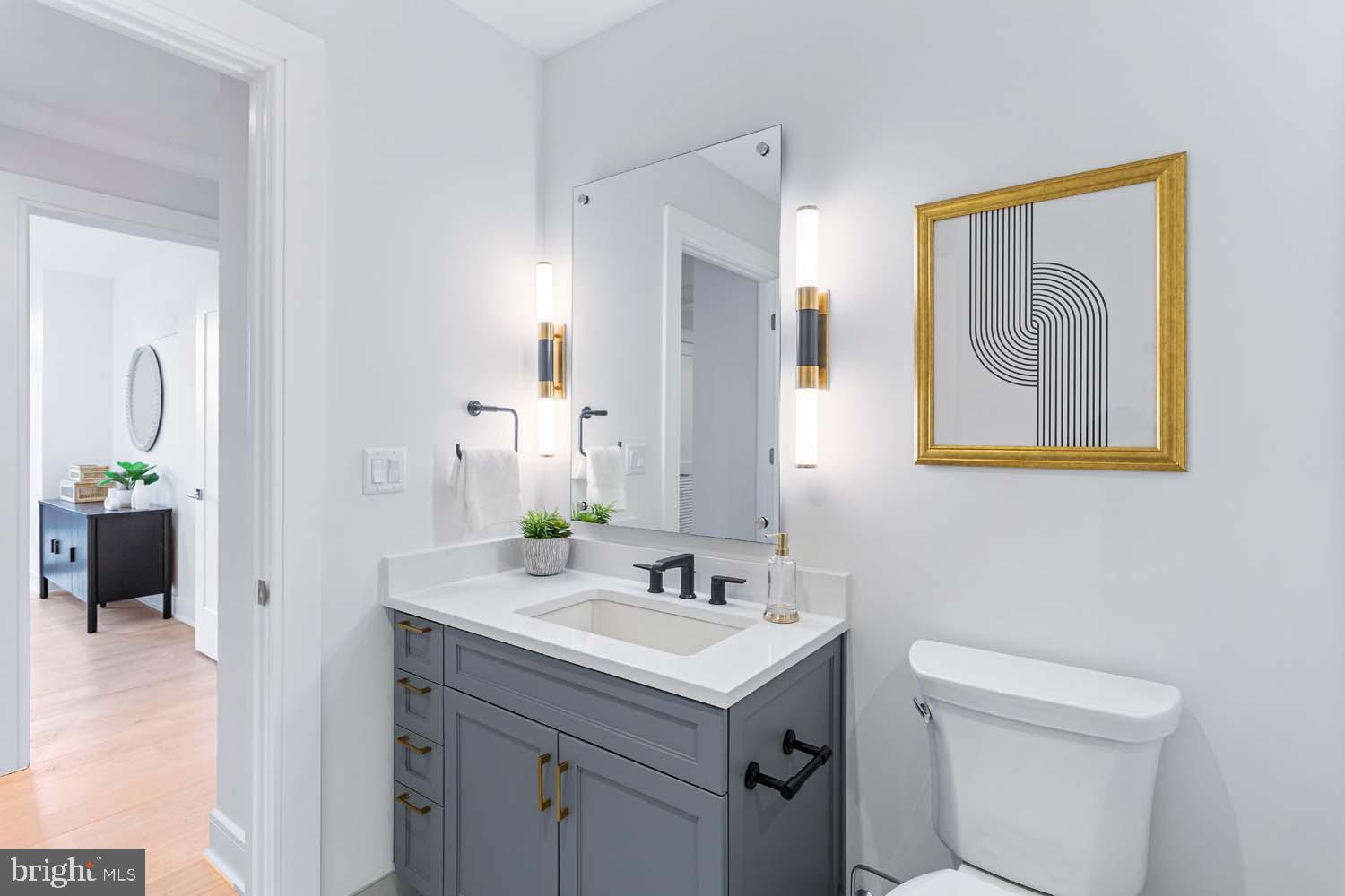 6718 Lowell Avenue, Unit 406 McLean, VA 22101 - Photo 37 of 86 a bathroom with a toilet sink and mirror